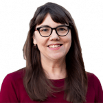 An enhanced color photographic cutout of a glasses wearing Deborah Boyle with long brown air hanging down her front lower than her shoulders wearing a dark red rounded neck sweater used to visually identify her.