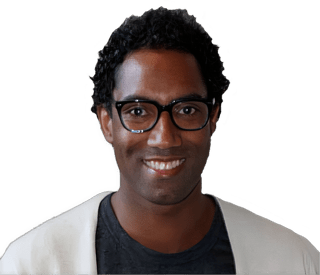 An enhanced color photographic cutout headshot of a glasses adorned smiling Elliot Samuel Paul wearing a black shirt with rounded collar under a white sports coat used for visually identifying a him.