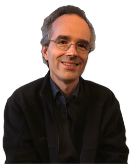 A reversed enhanced color photographic headshot and torso cutout of a smiling glasses adorned Lionel Shapiro wearing a dark jacket over a dark blue shirt used for visually identifying him.