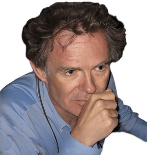 An enhanced color photographic headshot cutout of Galen Strawson wearing a blue shirt with his right hand in a fist at his mouth used for visually identifying him.