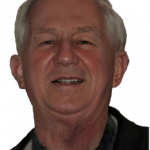 An enhanced. olorized rotated photographic headshot cutout of a white haired Elmar J. Kremer wearing a gray and black shirt under a black jacket used for visually identifying him.
