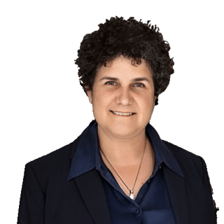 An enhanced color photographic cutout of Lisa. Shapiro wearing a collared dark blue shirt under a black jacket and a silver necklace with a pearl pendant around her neck used for visually identifying her.
