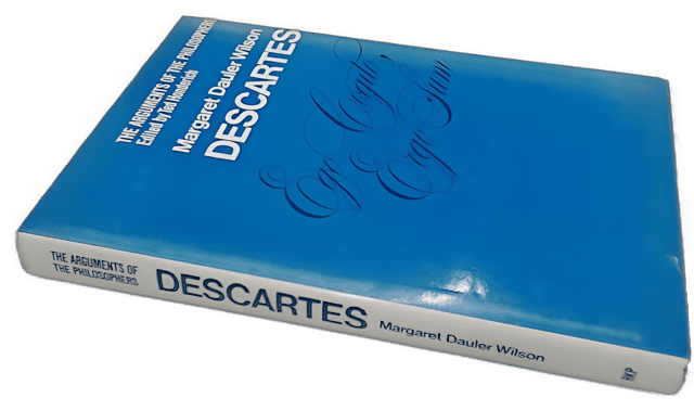 An enhanced 3D image of the blue covered book cover of "Descartes" by Margaret D. Wilson laying on its side at an upward left angle with the spine exposed used to visually identify it.