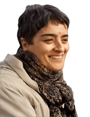 A reversed enhanced color photographic headshot cutout of a smiling Ethel Rocha turned towards her left wearing a scarf wrapped around her neck and a tan outer coat used to visually identify her.