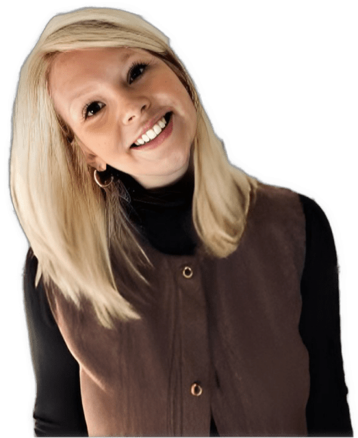A reversed enhanced color upper torso and head-shot photographic cutout of a glasses wearing Lauren Slater with her head leaning strongly to her right wearing a black turtleneck with long sleeves under a brown sweater with two large buttons showing used to visually identify her.