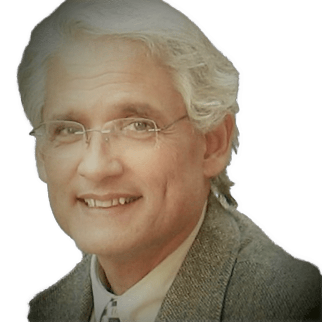 An enhanced color photographic headshot cutout of Pedro V. Amaral with rimless glasses and wearing a tan collared shirt under a gray/greenish sport coat used to visually identify him.