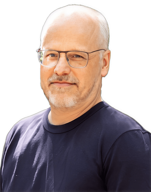 A reversed enhanced color photographic upper torso and headshot cutout of Gideon Yaffe wearing glasses and a purple rounded-neck shirt is used for visual identification. 