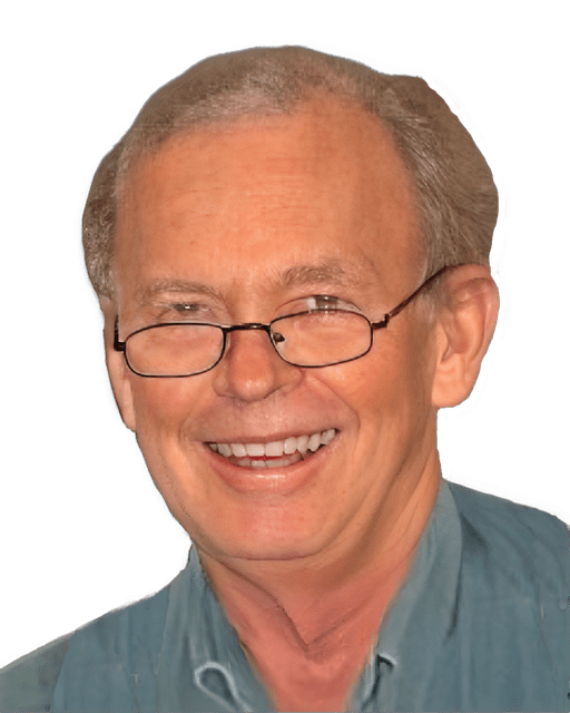 An enhanced colorized photographic headshot of Terry Penner, smiling with his glasses pushed down his nose and wearing a collared blue shirt, is used for visual identification.