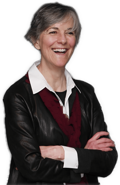 A reversed enhanced photographic cutout of Margaret D. Wilson from the waist up with her arms folded, wearing glasses and an oversized collared white shirt under a red sweater with a black leather jacket is used for visual identification.