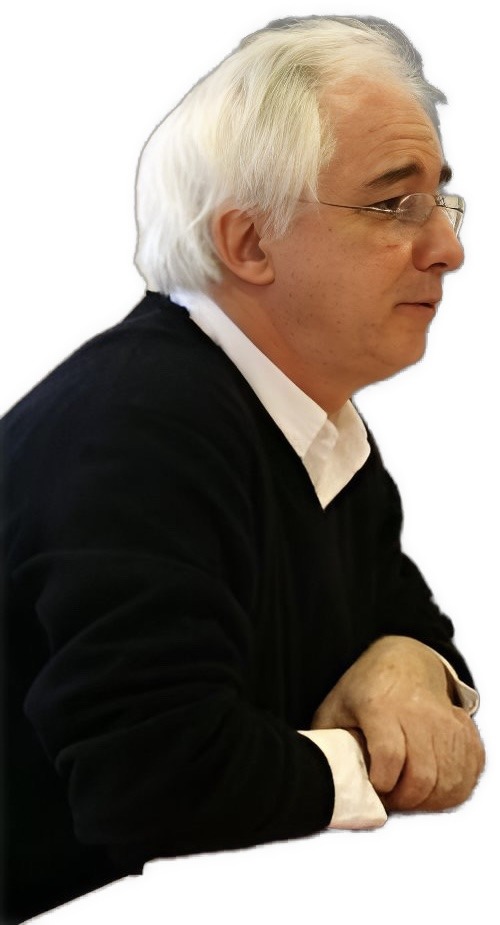 An enhanced color upper torso and head photographic cutout of Denis Kamboucher in right profile wearing glasses, a white collared shirt under a black sweater is used for visual identification.