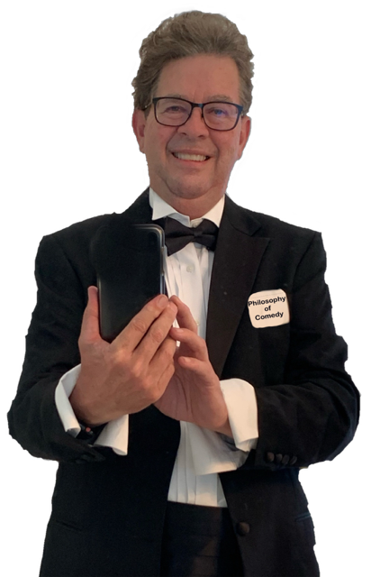 A photographic cutout of Dr. David C. Ring in a black tuxedo holding his phone with a name tag on his left chest reading “Philosophy of Comedy” is used for visual identification.
