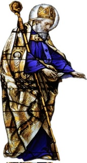 A color stain glass window of St. Augustine turned towards his left, looking down with a staff under his right forearm.
