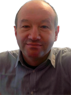 An enhanced colorized photographic headshot and upper chest cutout of an unsmiling barely bearded Daniel Schmal wearing a medium gray collared shirt is used as visual identification.