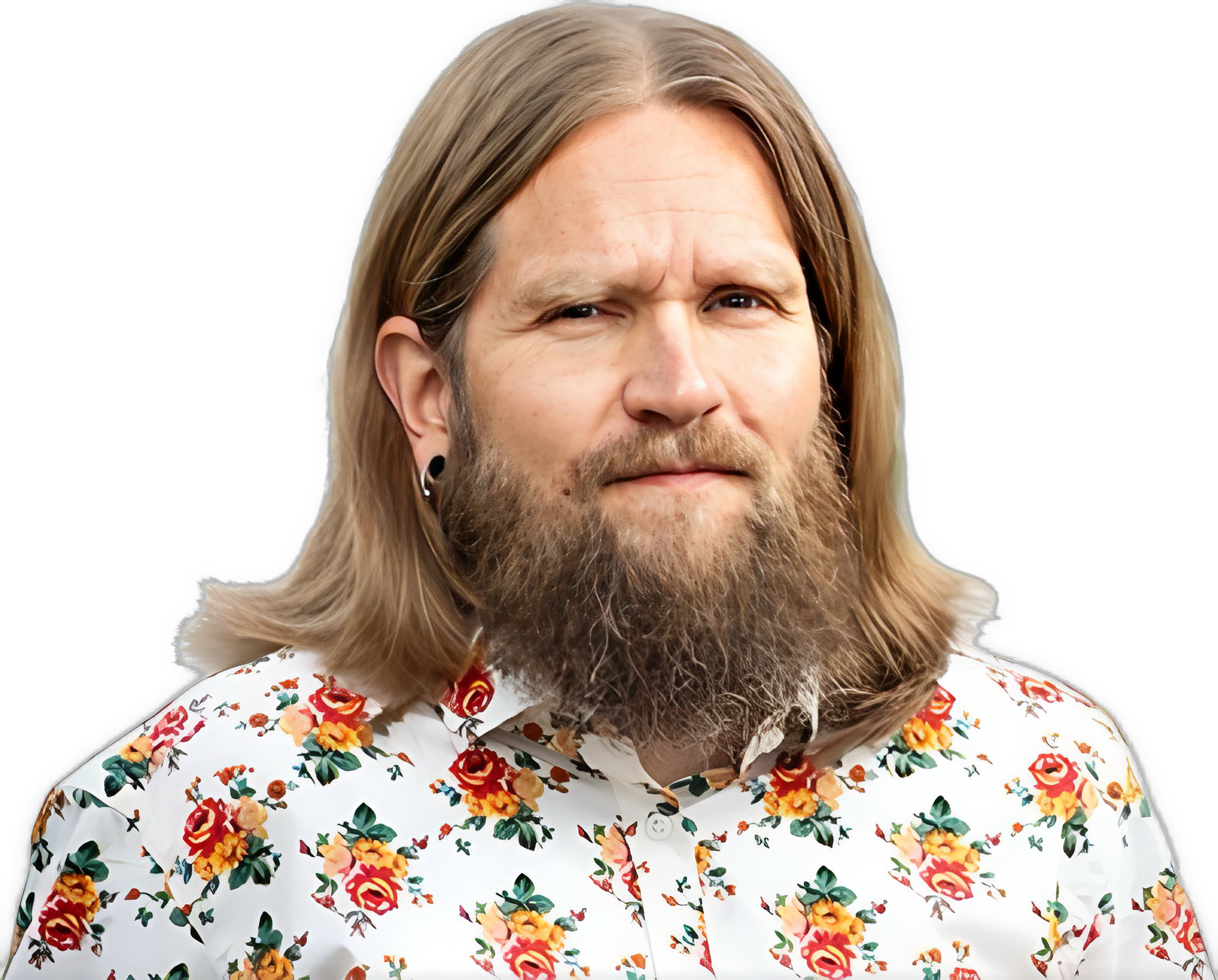 An enhanced photographic cutout of Jani Sinnoki, with a full beard and light brown, shoulder-length hair parted in the middle, wearing a white collared shirt with a red flower surround at the base, yellow flowers, and three green leaves, is used to identify him visually.