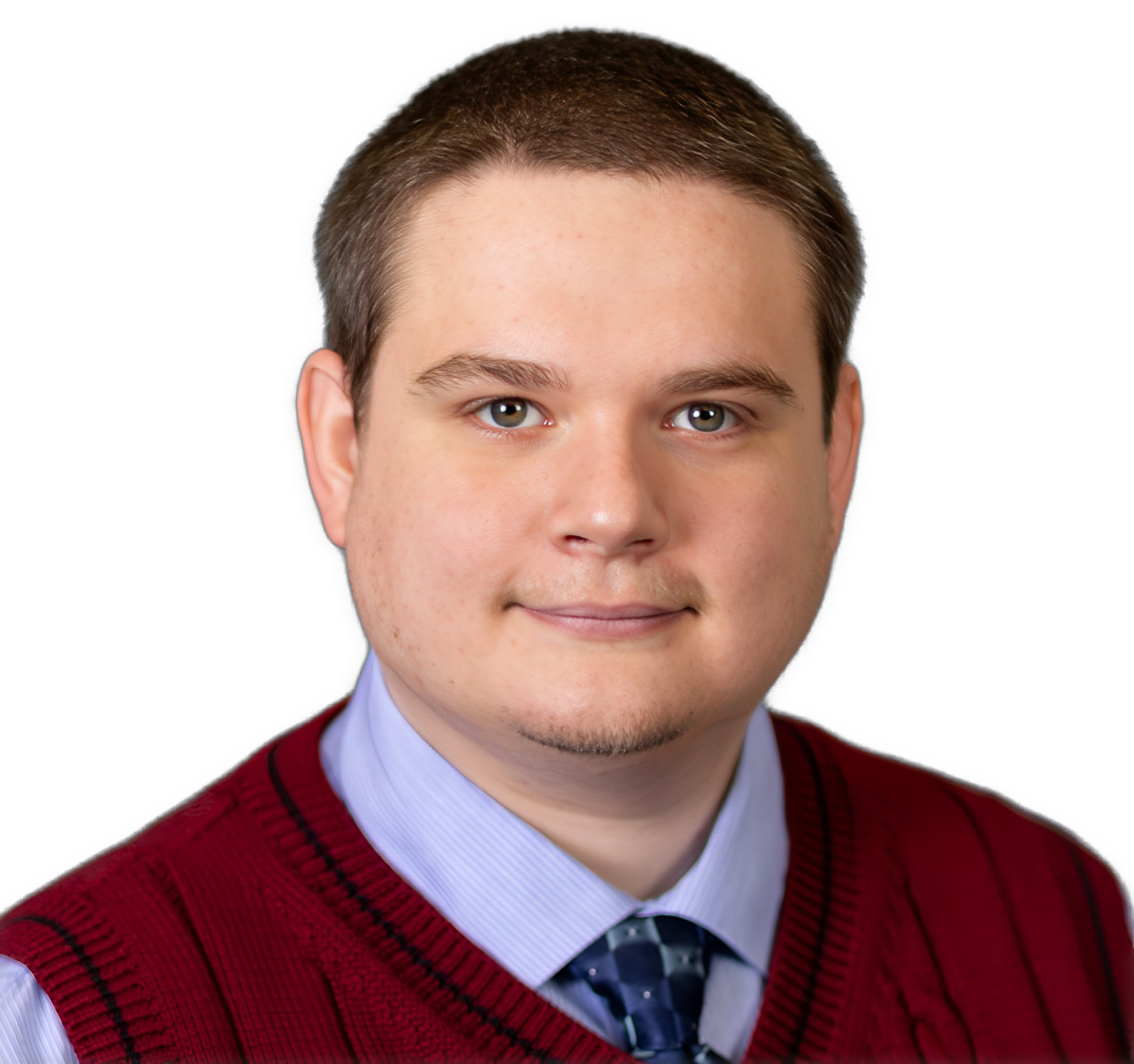 An enhanced photographic cutout of Dr. Travis Tanner, wearing a lavender shirt with a blue necktie under a red sleeveless sweater with blue piping, is used to identify him visually.