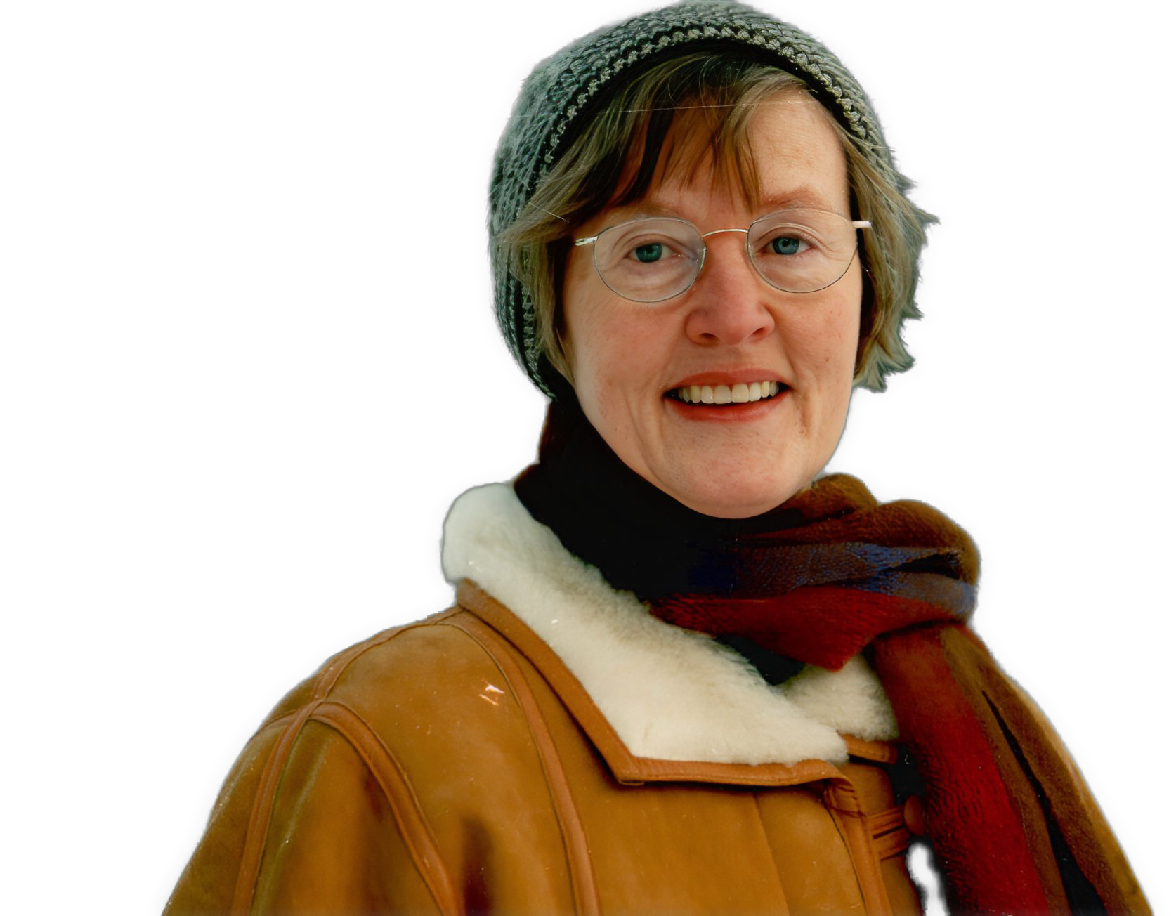 This photograph captures Lili Alanen smiling warmly at the camera, a woman with short light-brown hair, round silver-framed glasses, bright blue eyes, and rosy cheeks, dressed in a gray knitted hat, a brown leather jacket with a white shearling collar, and a colorful red-blue-black plaid scarf over a black turtleneck against a solid black background.
